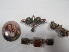 A VICTORIAN SCOTTISH HARDSTONE BROOCH AND THREE OTHERS