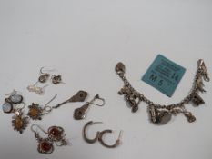 A VINTAGE SILVER CHARM BRACELETS AND CHARMS TOGETHER WITH A SMALL SELECTION OF MAINLY SILVER
