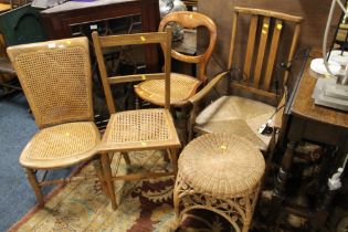 THREE ANTIQUE BERGERE CHAIRS WITH A WICKER STOOL AND AN OAK CHAIR