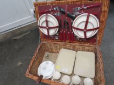 A VINTAGE WICKER PICNIC BASKET WITH HALF CONTENTS