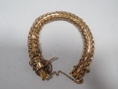 A YELLOW METAL FANCY LINK BRACELET WITH INDISTINCT MARKS TO CLASP