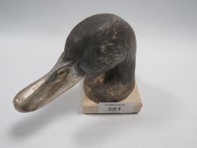 A VINTAGE METAL PAPER WEIGHT DEPICTING DUCKS HEAD MOUNTED ON A STONE BASE