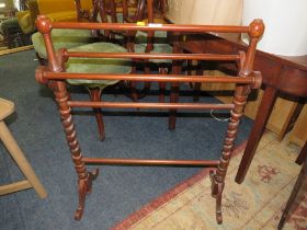 AN EDWARDIAN MAHOGANY TOWEL RAIL