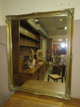 A LARGE MODERN GILT FRAMED RECTANGULAR MIRROR 127 x 105 cm