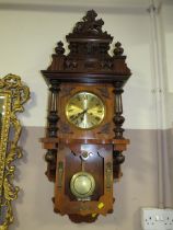 AN EDWARDIAN WALNUT WALL CLOCK