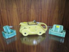 A VINTAGE SADLER RACING CAR TEAPOT IN YELLOW, TOGETHER WITH TWO SIMILAR STYLE SOFAS (3)
