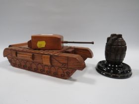 A NOVELTY TREEN BOX IN THE FORM OF A TANK TOGETHER WITH A FIRST WORLD WAR HAND GRENADE INKWELL
