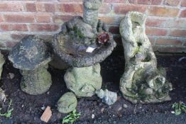THREE CONCRETE GARDEN STATUES / ORNAMENTS TO INCLUDE A BIRD BATH, A MUSHROOM AND A WATER FEATURE