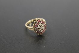 A HALLMARKED 9 CARAT GOLD RUBY AND DIAMOND CLUSTER RING approx weight 3.6g