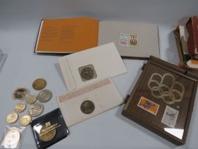 A COLLECTION OF COMMEMORATIVE COINS AND OLYMPIC STAMPS