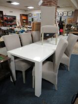 A MODERN WHITE GLOSS DINING TABLE WITH SIX UPHOLSTERED CHAIRS