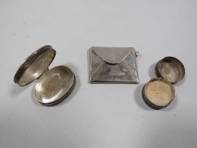 A MODERN 925 SILVER PILL BOX TOGETHER WITH ANOTHER AND A WHITE METAL ENVELOPE STAMP STYLE HOLDER (