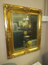 A GILT FRAMED RECTANGULAR MIRROR 67 x 57 cm