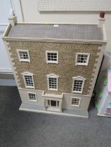 A LARGE THREE STOREY DOLLS HOUSE WITH CONTENTS