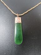 A CARVED JADE PENDANT ON A HALLMARKED 9 CARAT GOLD ROPE TWIST CHAIN approx weight chain 7.8g