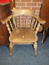 AN ANTIQUE SMOKERS BOW ARMCHAIR