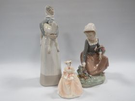 A LLADRO FIGURINE OF GIRL PICKING FLOWERS A/F TOGETHER WITH A LLADRO FIGURE OF A GIRL HOLDING A LAMB