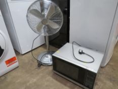 A SHARP MICROWAVE AND A FLOORSTANDING FAN