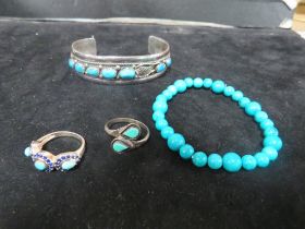 A SELECTION OF TURQUOISE STYLE JEWELLERY . TWO RINGS AND TWO BRACELETS (4)