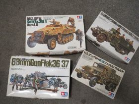 FOUR TAMIYA MILITARY MODEL KITS TO INCLUDE 88mm GUN FLAK36/37, Mt15SPW HALF TRACK AND US 2.5 TON 6x6