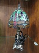 A SMALL TIFFANY STYLE TABLE LAMP