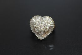 A HALLMARKED 18 CARAT GOLD HEART SHAPED DIAMOND CLUSTER RING, set with a combination of baguette and