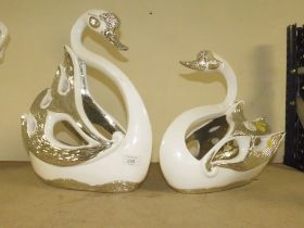 A DECORATIVE PAIR OF SILVER/WHITE SWAN FIGURES