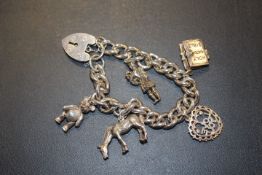 A HEAVY SILVER CHARM BRACELET approx weight 60.3g