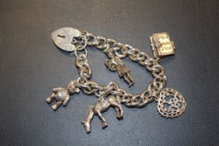 A HEAVY SILVER CHARM BRACELET approx weight 60.3g