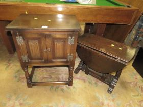 A SMALL OAK TWO DOOR CABINET AND A DROPLEAF TABLE (2)