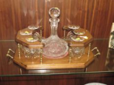 A TWIN HANDLED DRINKS STAND WITH DECANTER AND SIX BRANDY GLASSES
