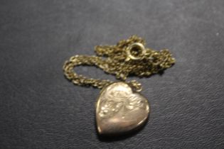 AN ANTIQUE LOCKET MARKED 9CT BACK AND FRONT