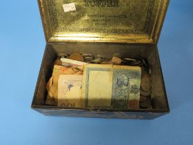A TIN OF WORLD COINS AND BANKNOTES