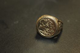 A HALLMARKED 9 CARAT GOLD GEORGE AND THE DRAGON RING approx weight 7.7g