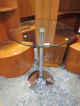 A MODERN GLASS BISTRO TABLE
