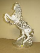 A DECORATIVE SILVER AND WHITE REARING HORSE MODEL
