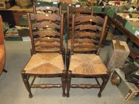 A SET OF FOUR OAK LADDER BACKED WICKERSEAT CHAIRS AND A TABLE