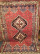 A LARGE RED WOOLLEN RUG TOGETHER WITH A SMALLER BLUE RUG AND A CHINESE RUG (3)