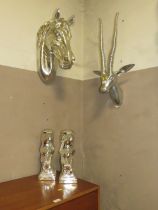A SILVERED METAL HORSES HEAD, IMPALA HEAD AND TWO EAGLE BOOKCASES