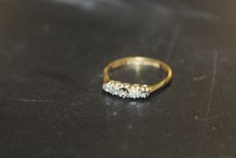 A HALLMARKED 18 CARAT GOLD DIAMOND RING - TWO STONES MISSING approx weight 2.8g