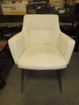 A MODERN WHITE UPHOLSTERED ARMCHAIR
