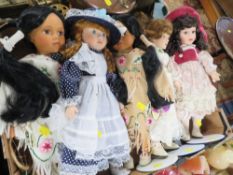 A TRAY OF MODERN PORCELAIN HEADED DOLLS ON STANDS