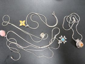 FIVE MODERN SILVER AND OTHER PENDANTS ON CHAINS