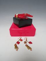 A BUTLER & WILSON RED HAND BROOCH TOGETHER WITH A PAIR OF MATCHED EARRINGS, BOXED, (2)