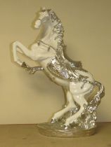 A DECORATIVE SILVER AND WHITE REARING HORSE MODEL