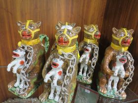 FIVE REPRODUCTION NOVELTY JUGS IN THE FORM OF A CAGE BEAR HOLDING A FELINE