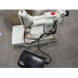 A CASED ELECTRIC SINGER SEWING MACHINE