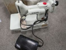 A CASED ELECTRIC SINGER SEWING MACHINE