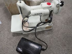 A CASED ELECTRIC SINGER SEWING MACHINE