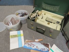 A CASED ELECTRIC BERNINA SEWING MACHINE TOGETHER WITH TWO TUBS OF SEWING ACCESSORIES